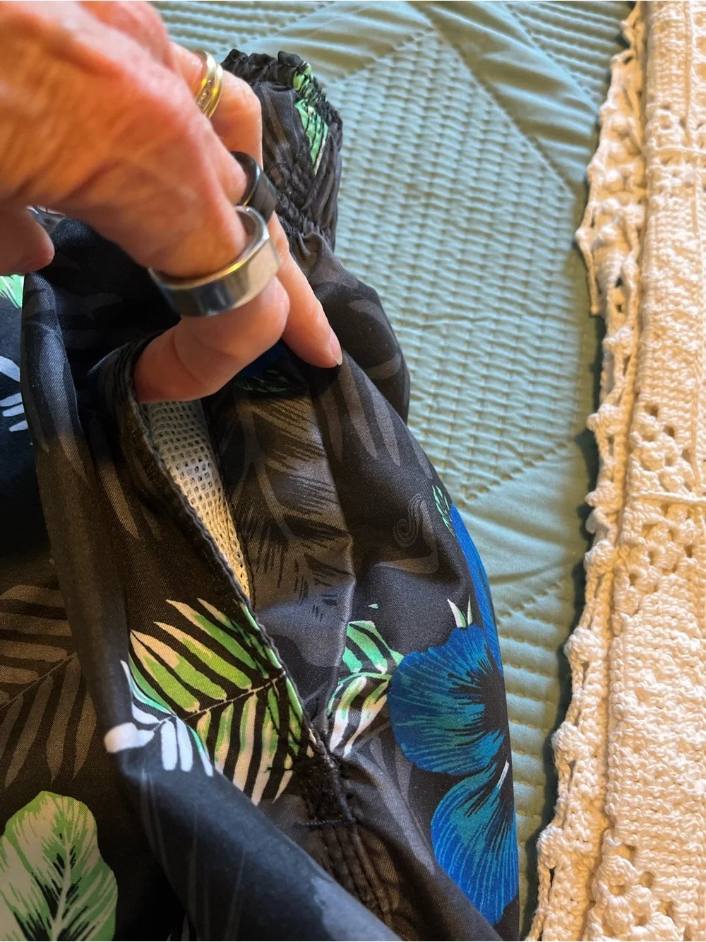 Pair of Kanu Surf Men's Blue Camo & Black Floral Swim Trunks